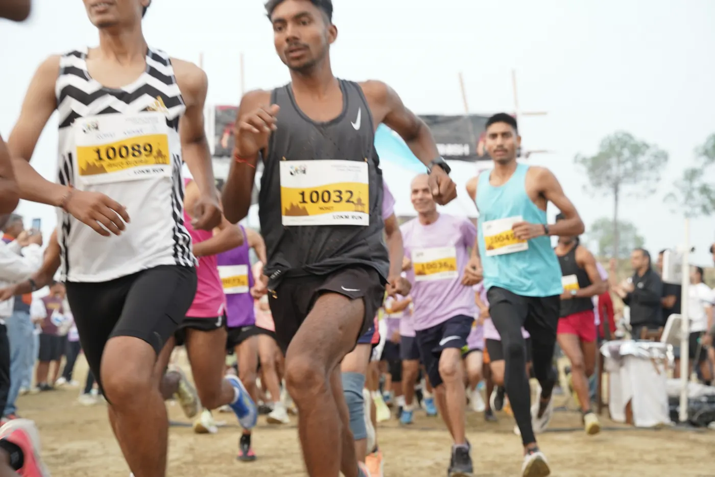 Two runners lead the pack off the start line at Kasar.