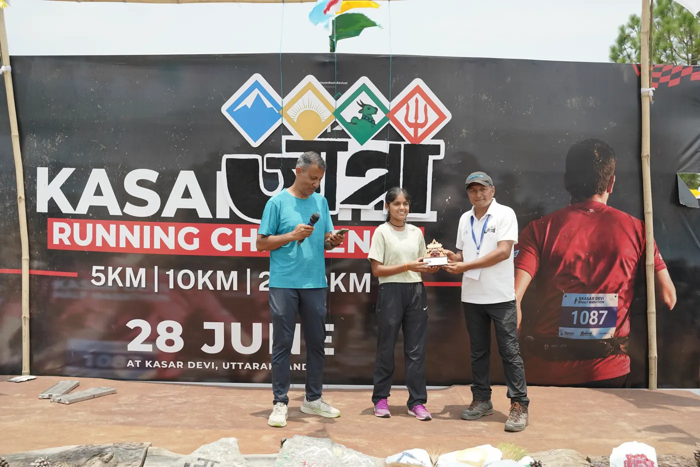 A finisher receiving a prize on the podium.