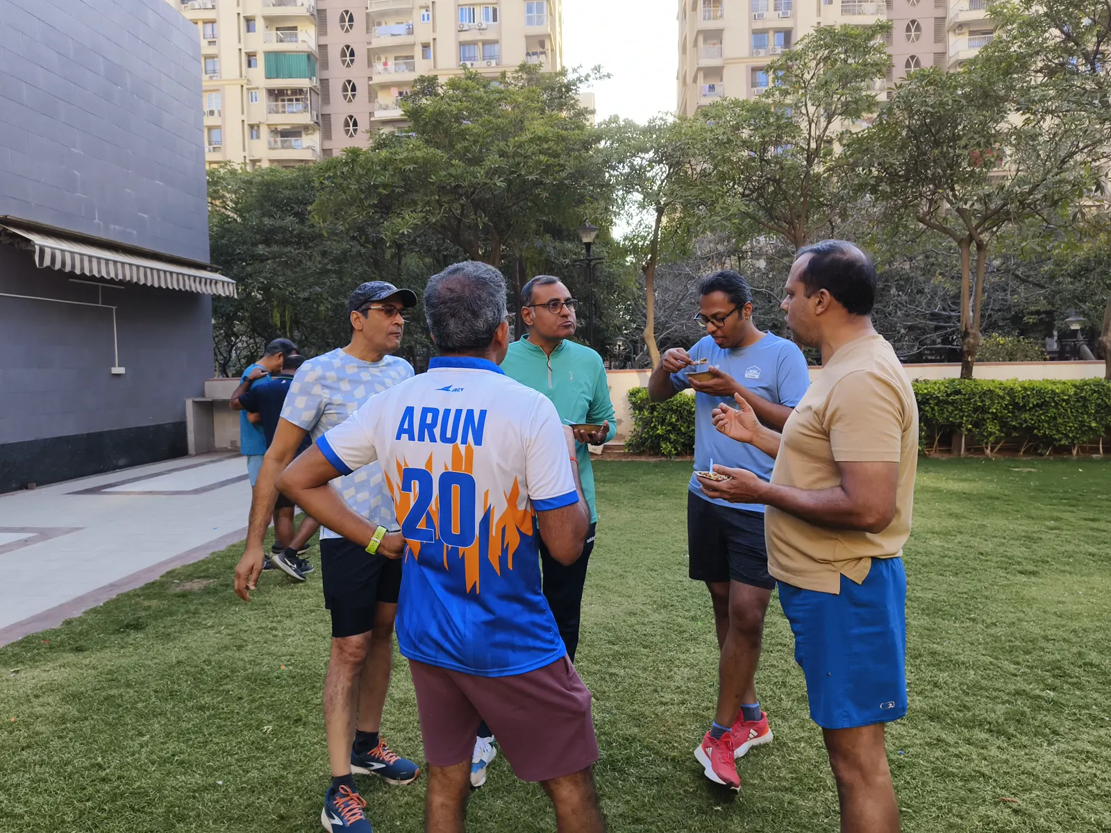 Runners in discussion with their coach after a session.