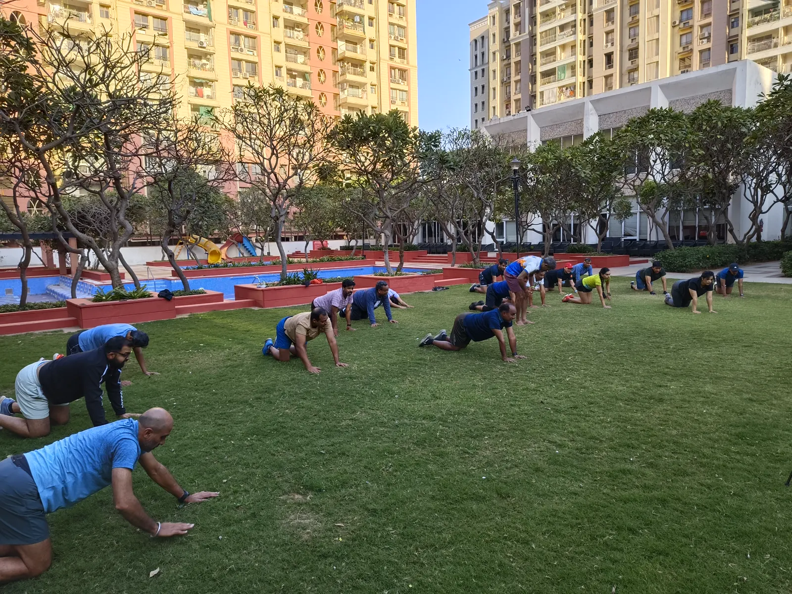 Runners doing strength drills on the grass at a RunActiv workshop.